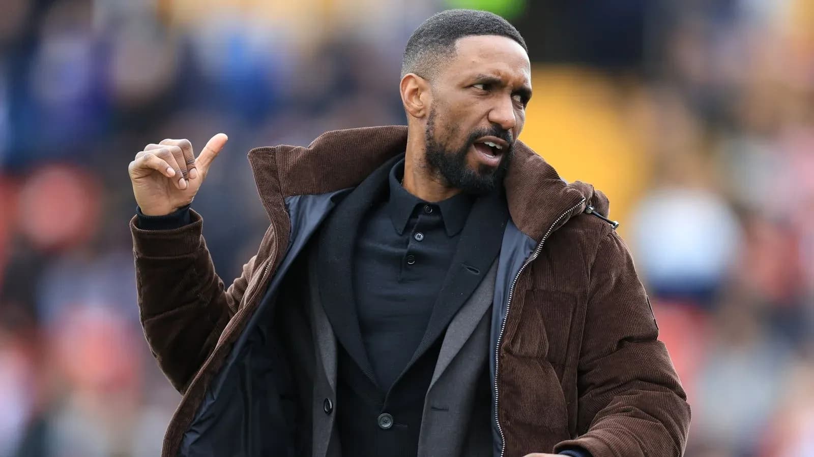 Coach gesturing during match on the sidelines