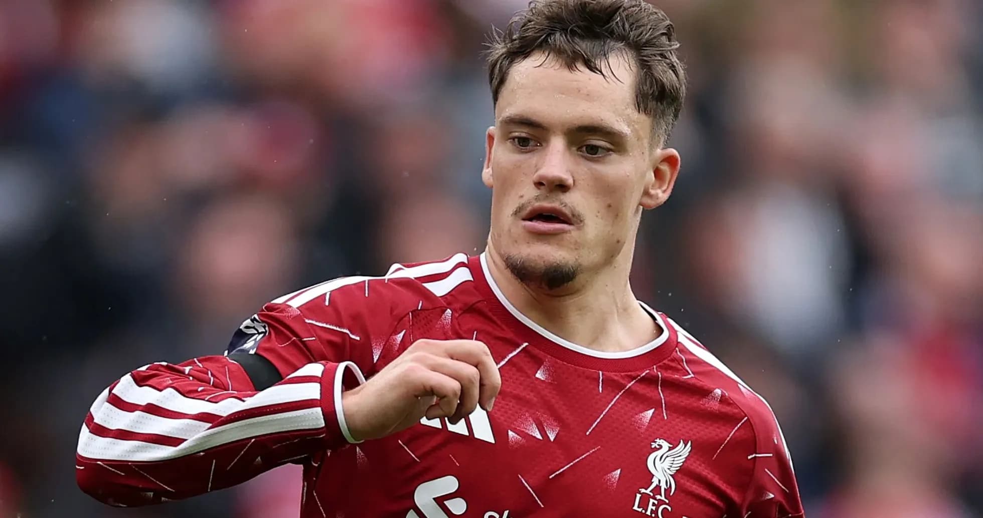 Player in Liverpool kit gesturing during match