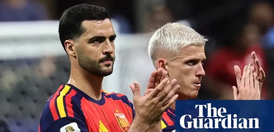 Two Spain players applauding fans after match