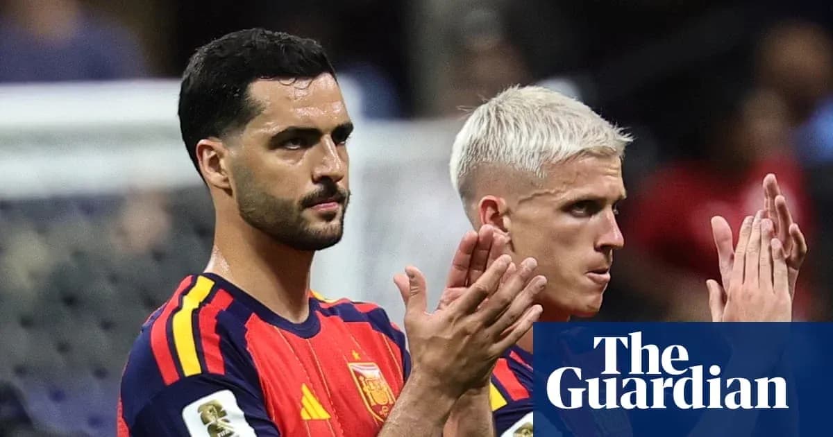 Two Spain players applauding fans after match
