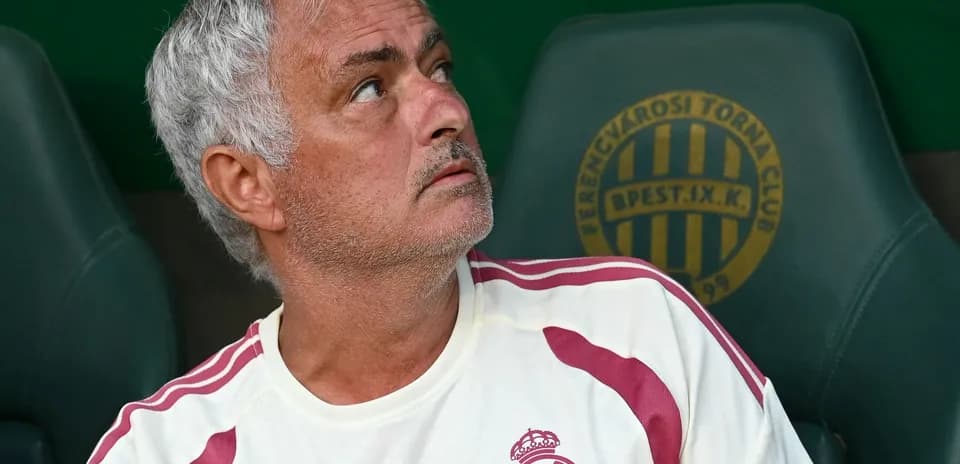 Coach sitting on bench looking upwards