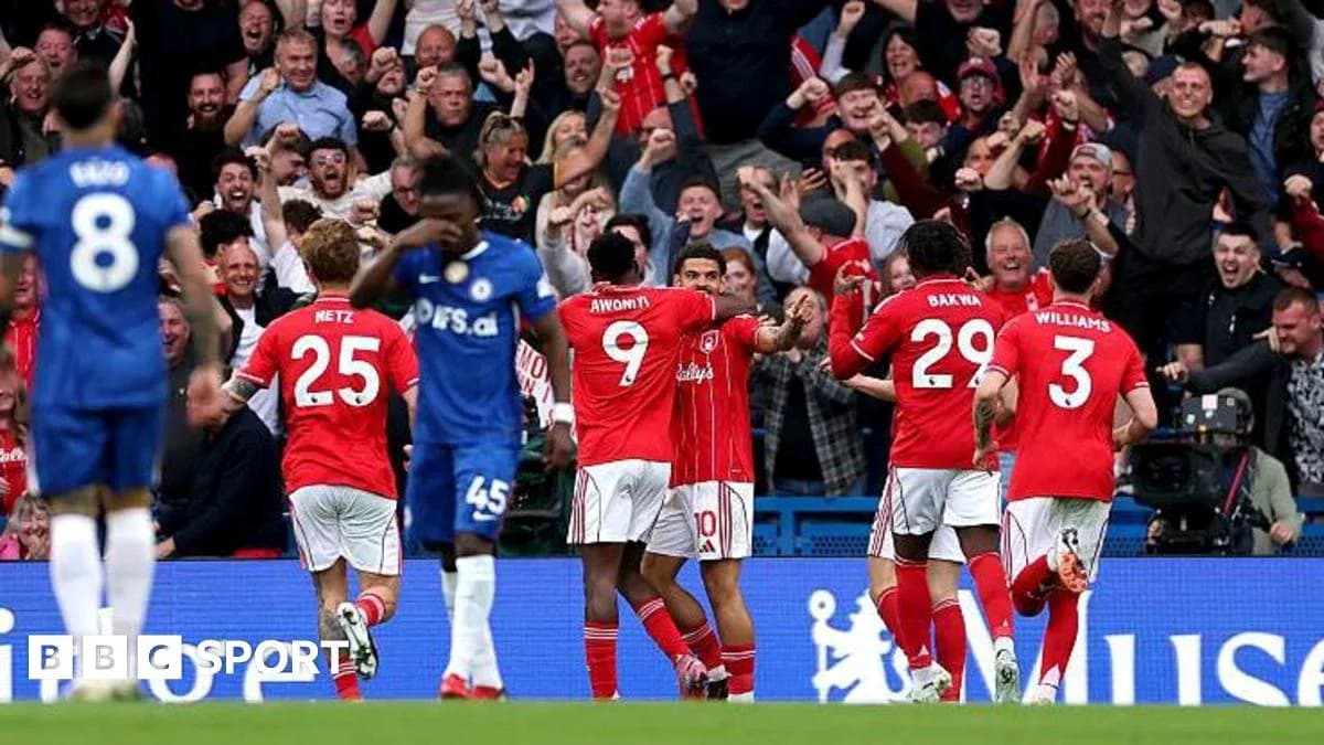 Players celebrating a goal with fans in background