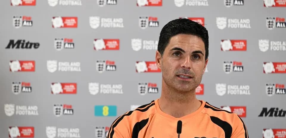 Manager speaking at press conference with logos