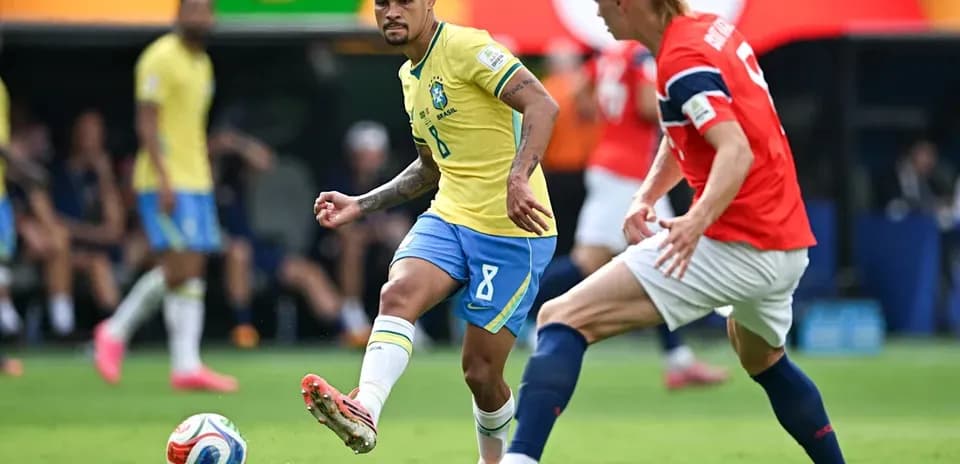 Brazilian player dribbling past opposing player during match
