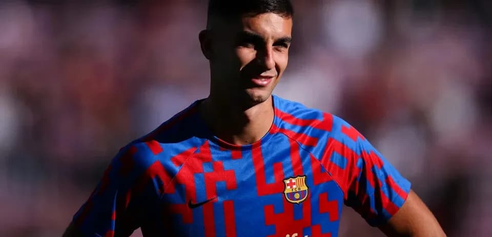 Player in Barcelona jersey smiling on the field
