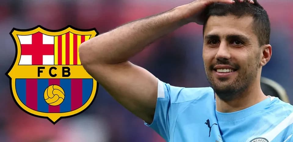 Player smiling with Manchester City jersey and Barcelona logo