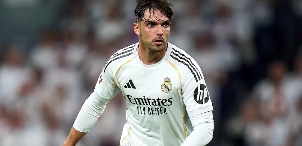 Player in white jersey running on the pitch