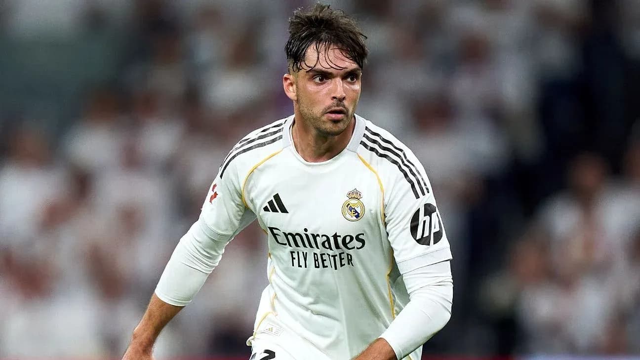 Player in white jersey running on the pitch
