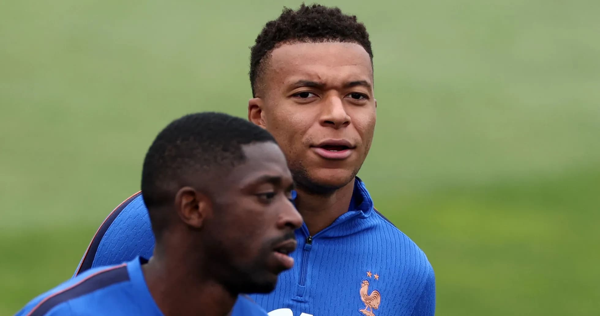 Two players training together in blue jerseys