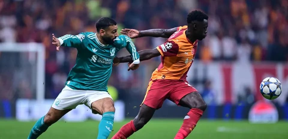 Liverpool player tackling Galatasaray opponent