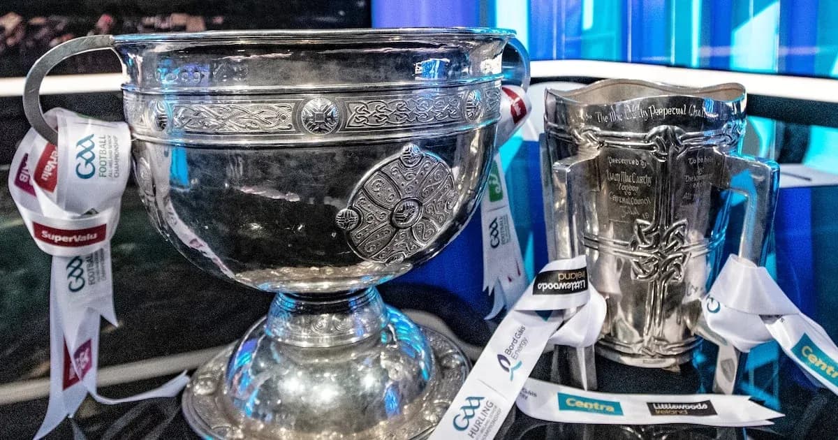 Two silver trophies with ribbons displayed together