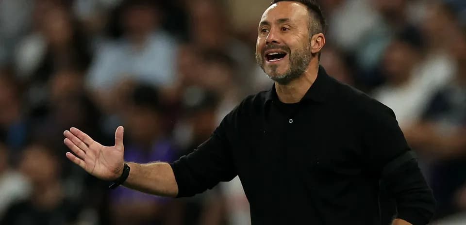 Coach gesturing during a match on the sidelines