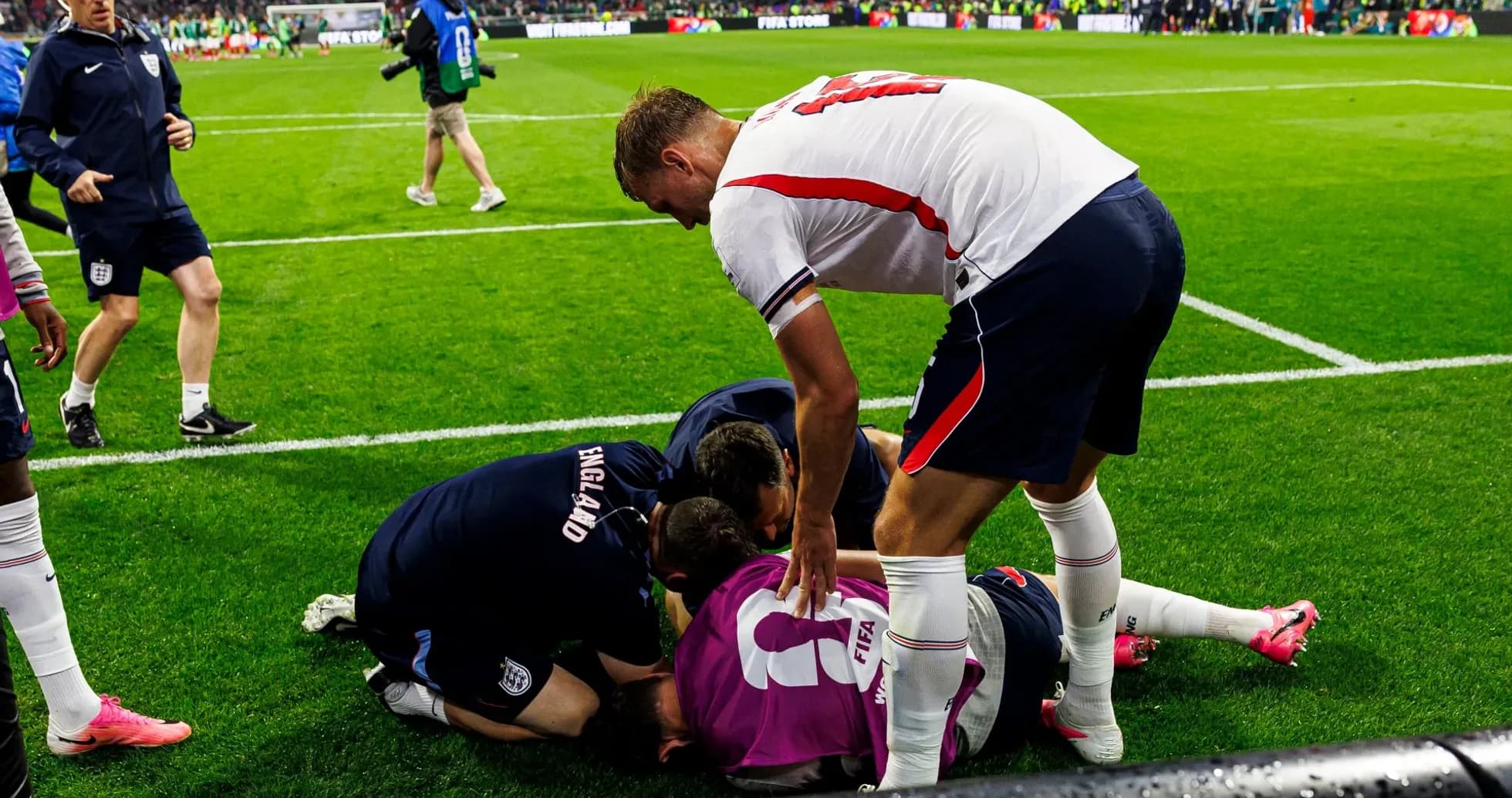 Players and staff attending to an injured goalkeeper