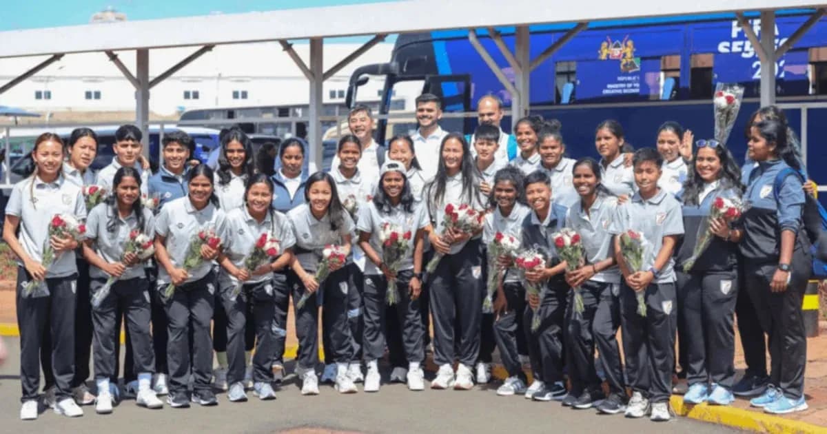 Women's cricket team posing with flowers at airport