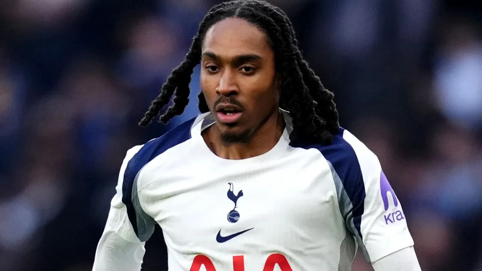Player running in Tottenham Hotspur kit during match