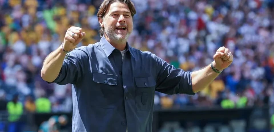 Coach celebrating during a match at the stadium