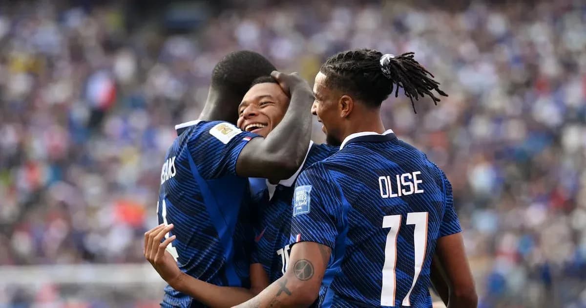 Three players celebrating a goal during match
