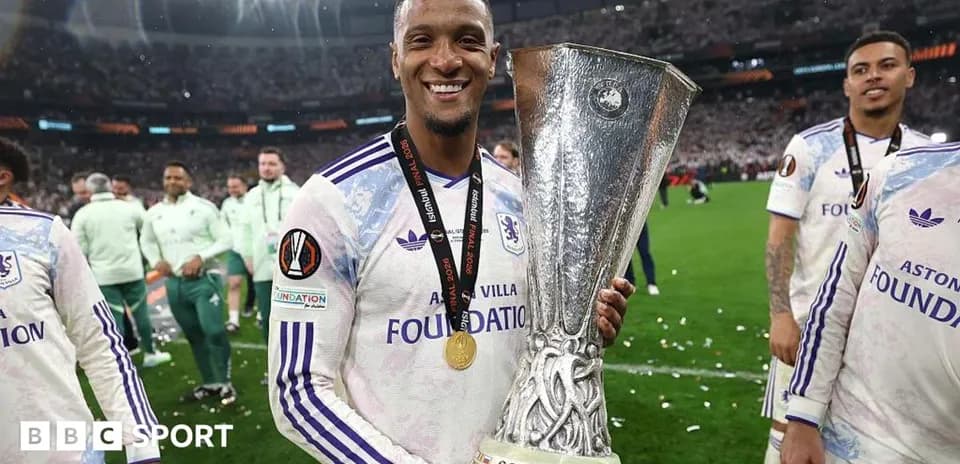 Player celebrating with UEFA trophy after match