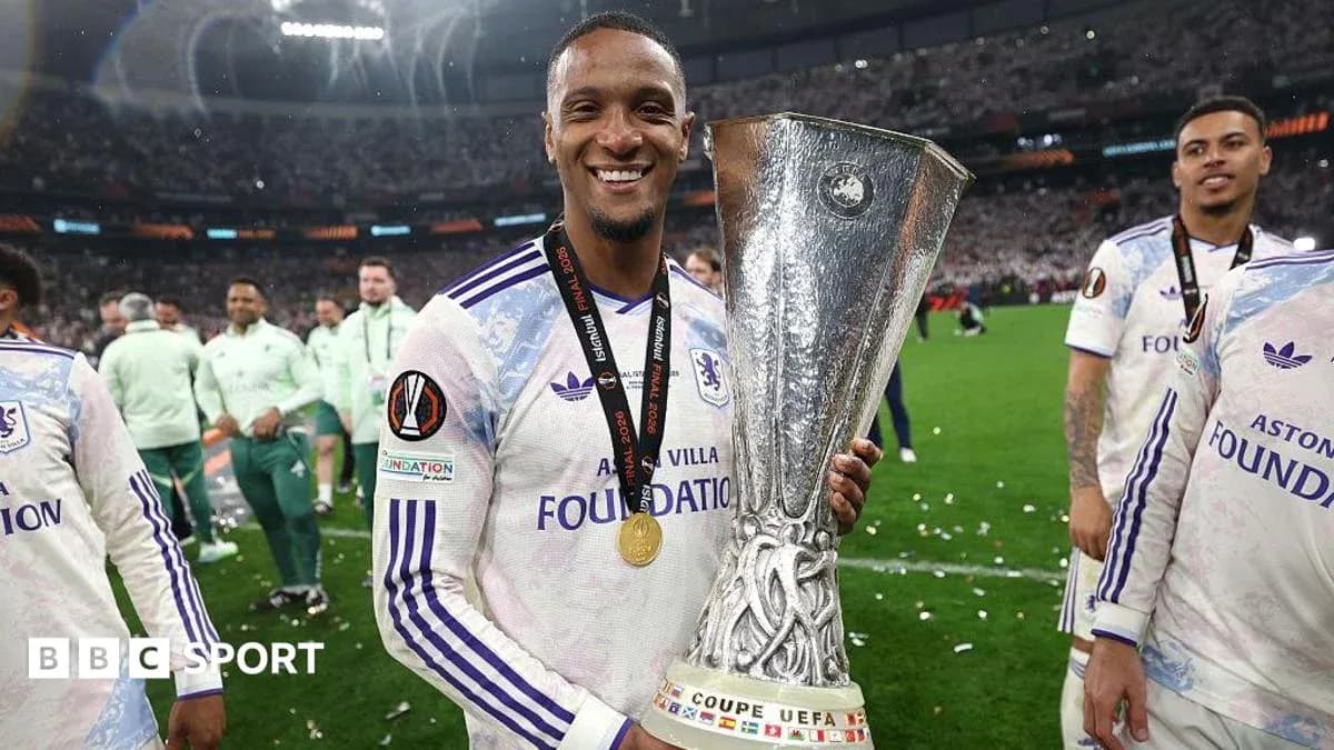 Player celebrating with UEFA trophy after match