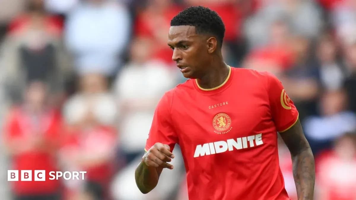 Player in red kit during football match action