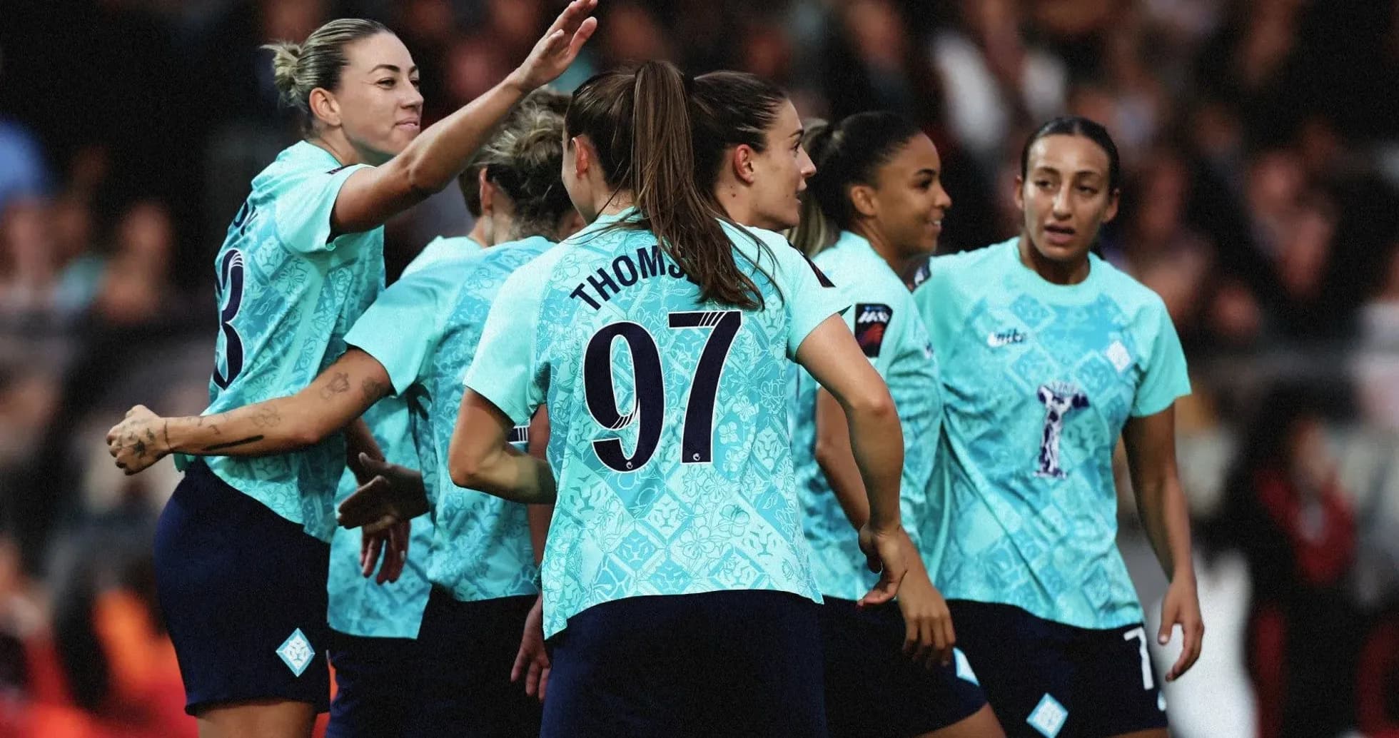Team celebrating a goal on the field