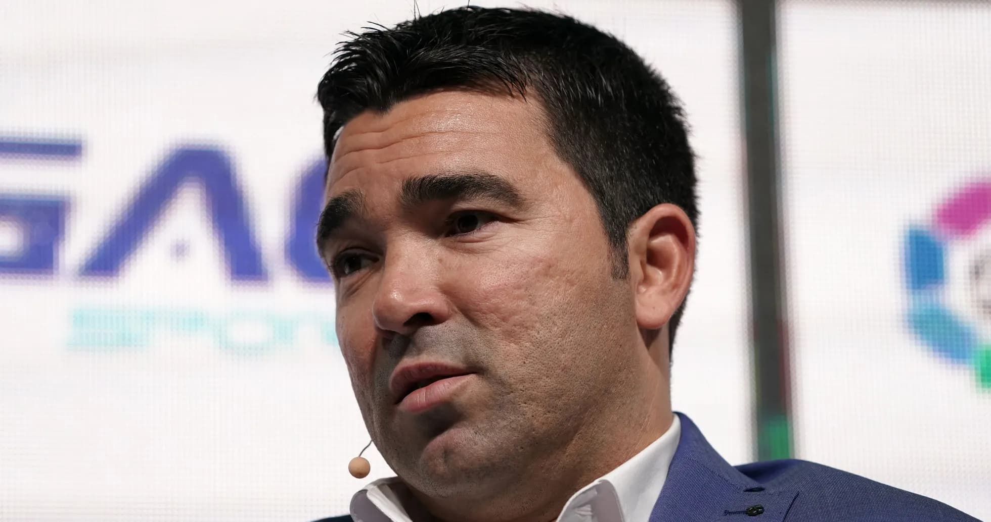 Person speaking at event with microphone attached