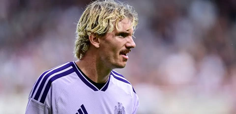 Player wearing Newcastle jersey during match action