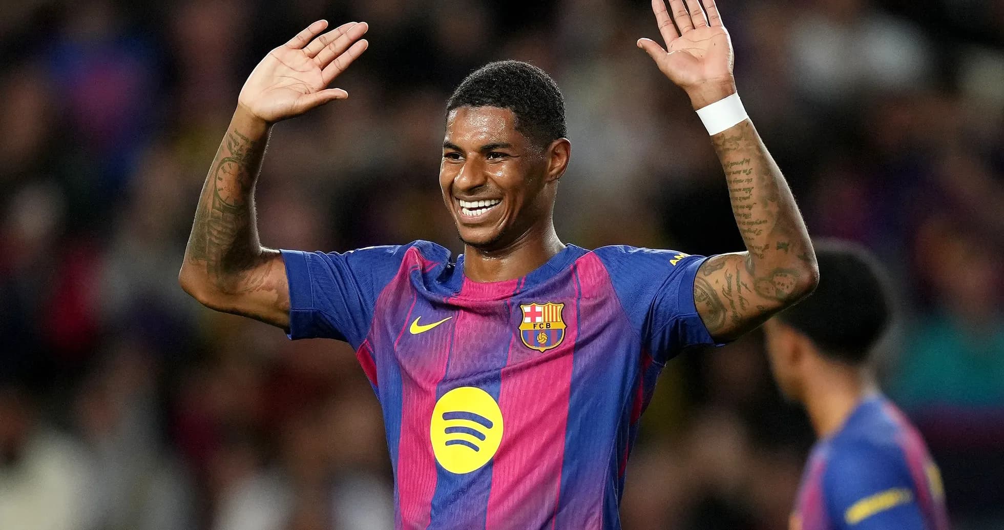 Player celebrating with raised hands on the pitch