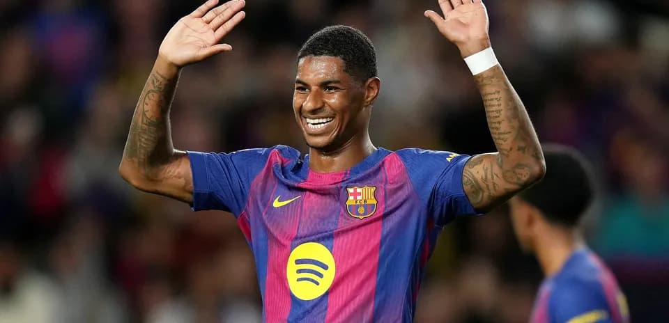 Player celebrating with raised hands on the pitch
