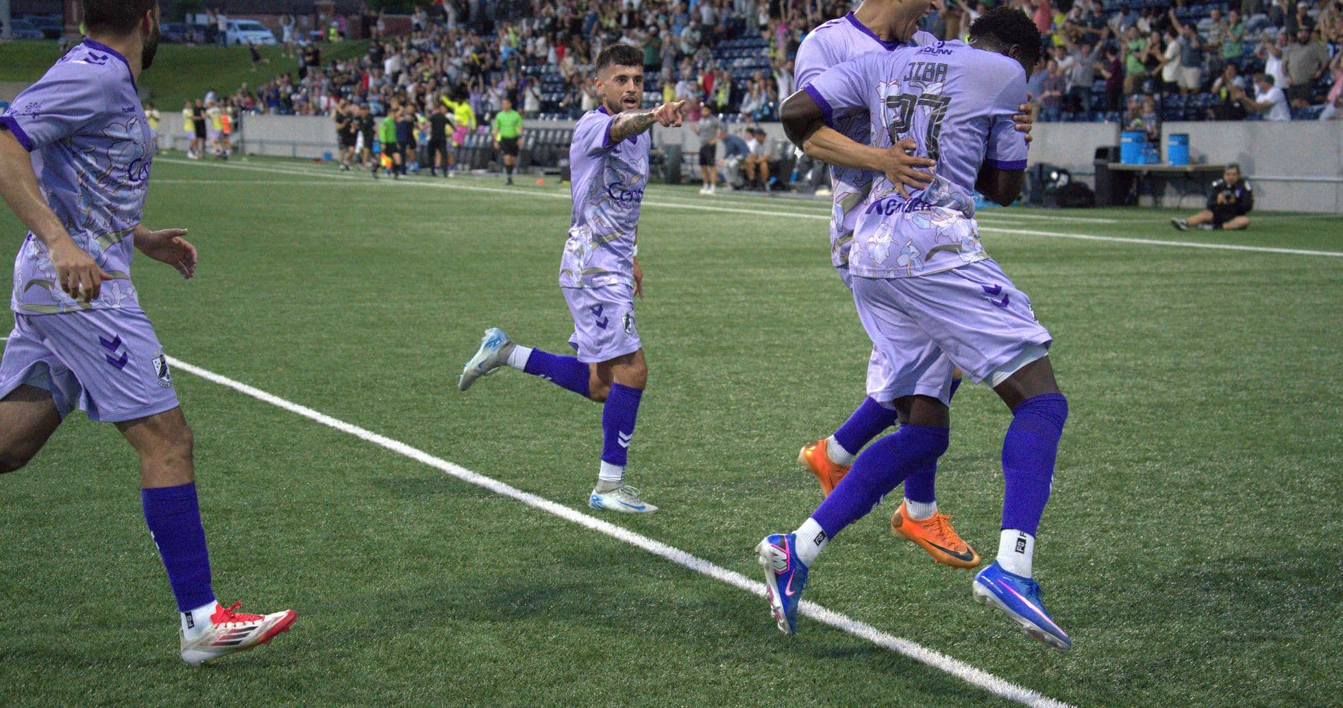 Players celebrating a goal during USL match