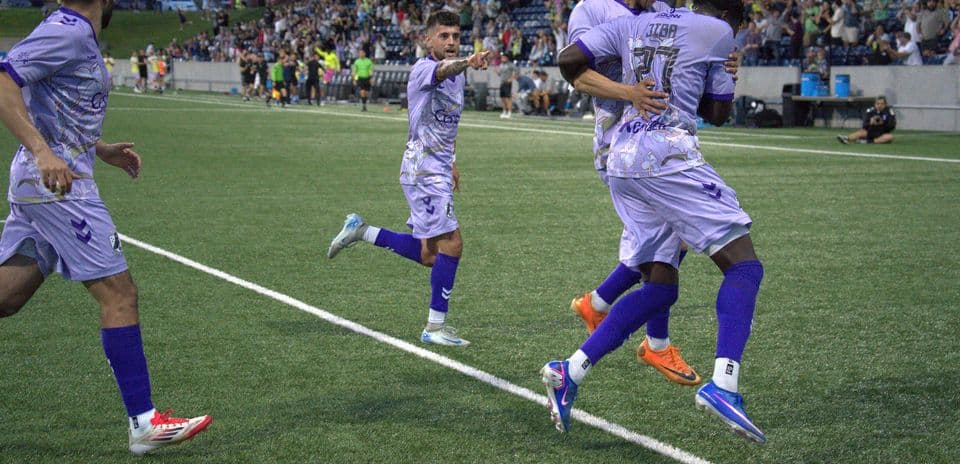 Players celebrating a goal during USL match