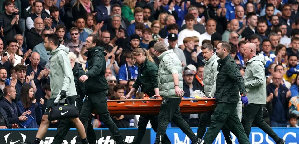 Medical staff carrying stretcher off the field