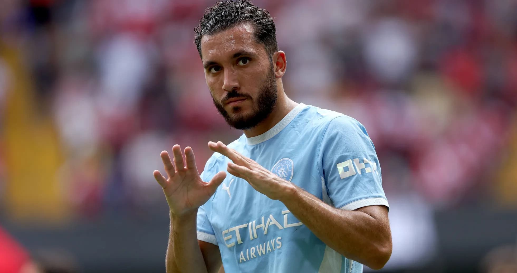 Player gesturing during warm-up on the pitch