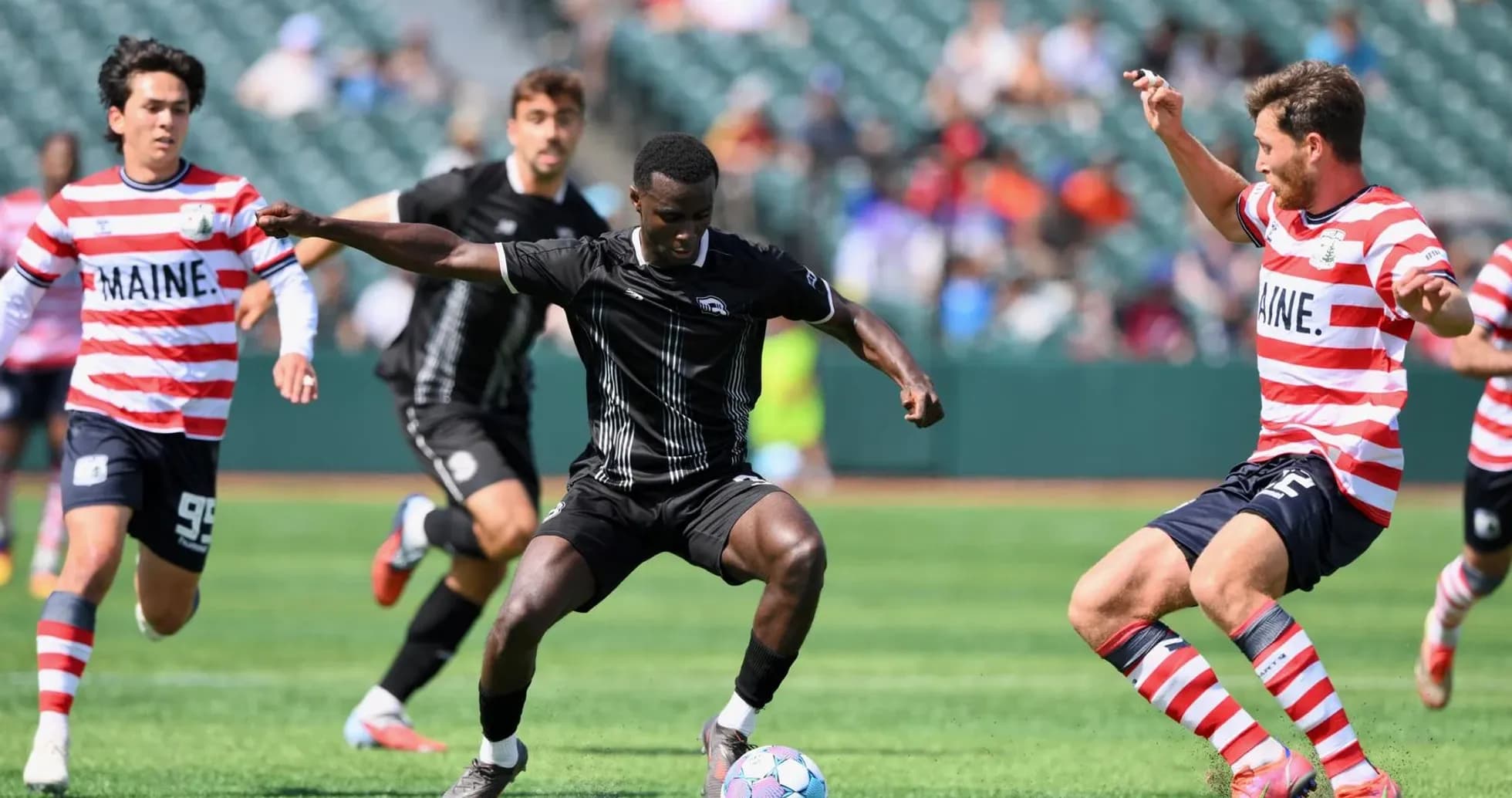Players competing for the ball in USL match