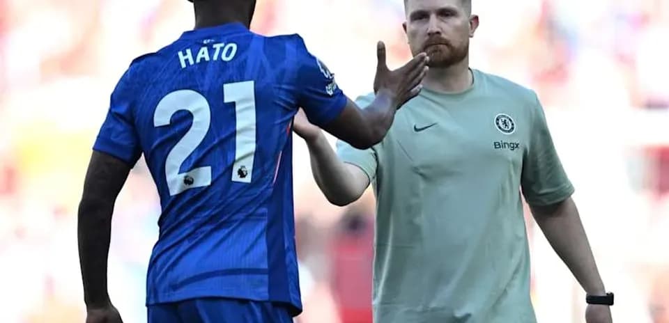 Player Hato greeting Chelsea staff during match