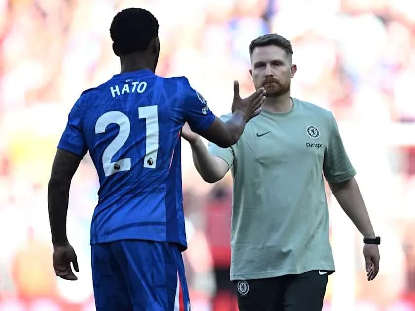 Player Hato greeting Chelsea staff during match