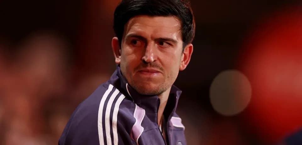 Player in Manchester United training jacket looking away