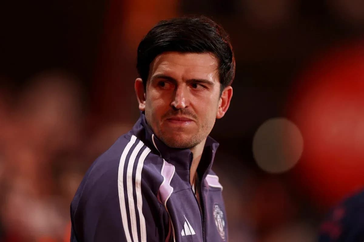 Player in Manchester United training jacket looking away