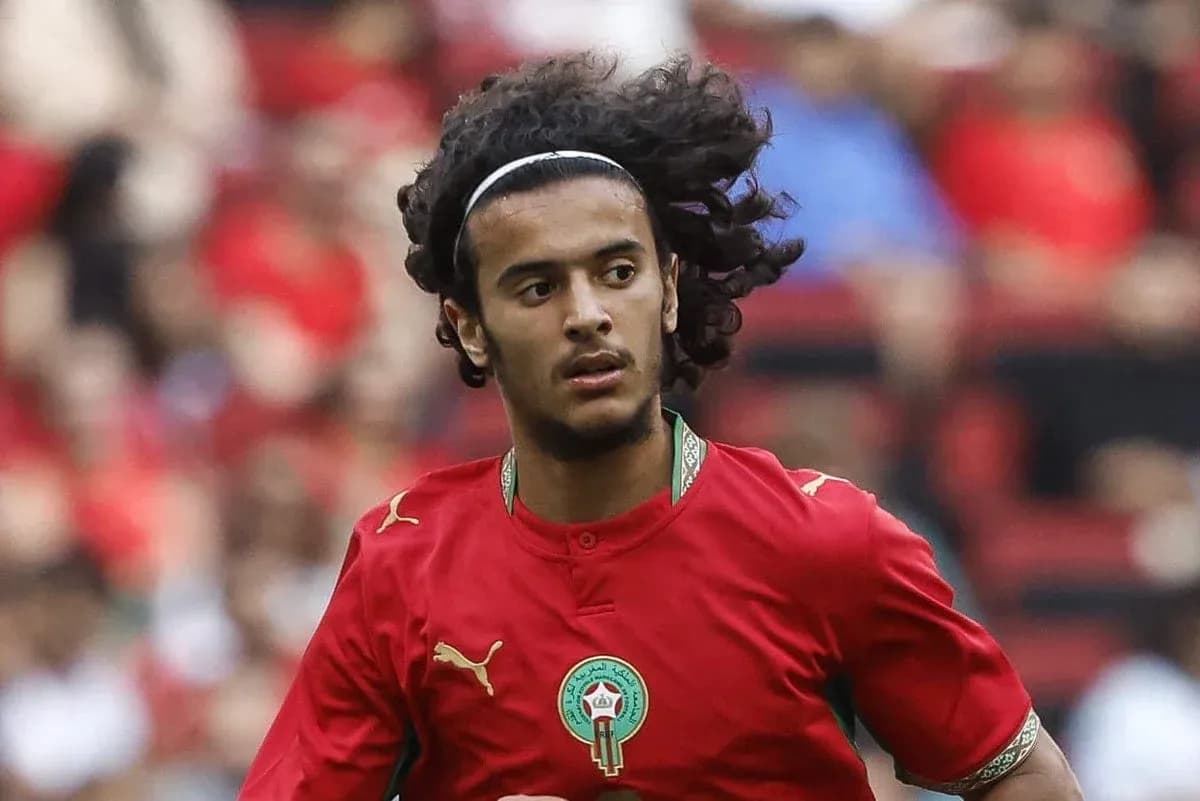 Player in red Morocco jersey running on field