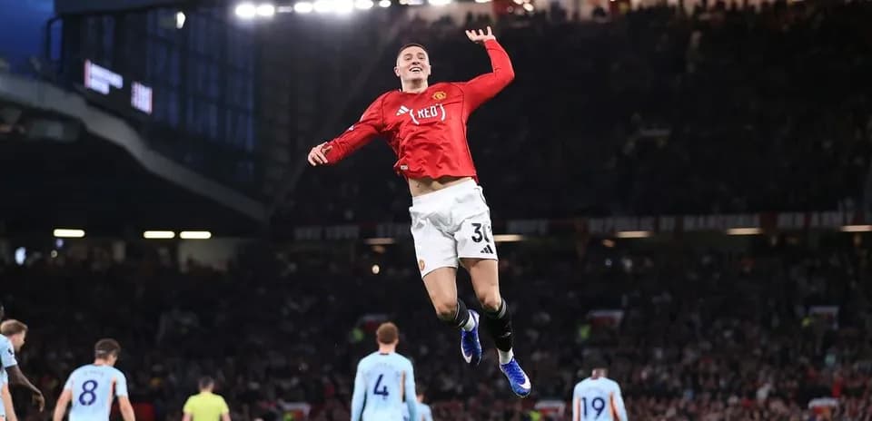 Player celebrating a goal at Old Trafford stadium