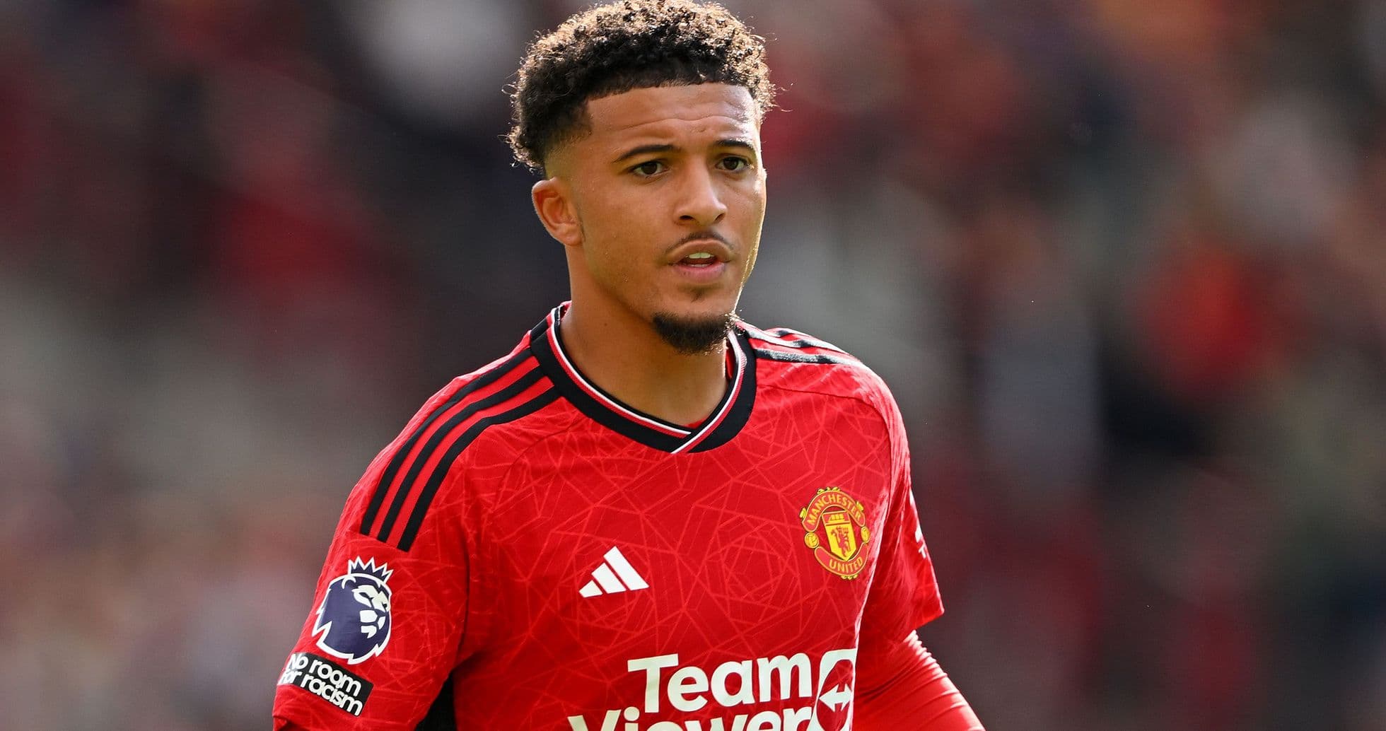 Player in Manchester United red kit on field