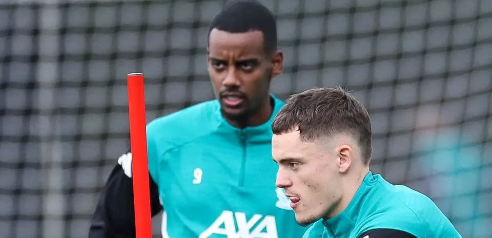 Two players training with a pole on the field