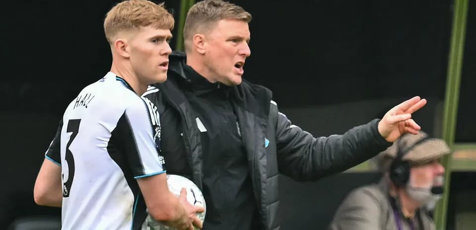 Coach instructing player during match substitution