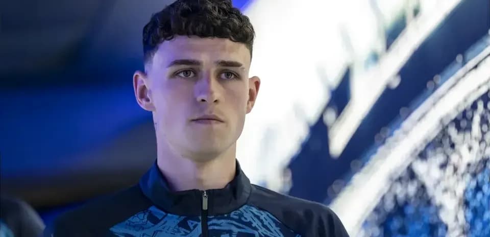 Player in Manchester City training kit looking focused