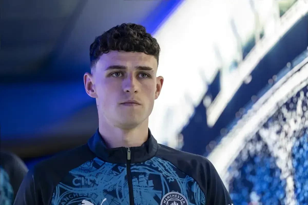 Player in Manchester City training kit looking focused