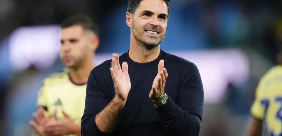 Manager clapping on the sidelines during match