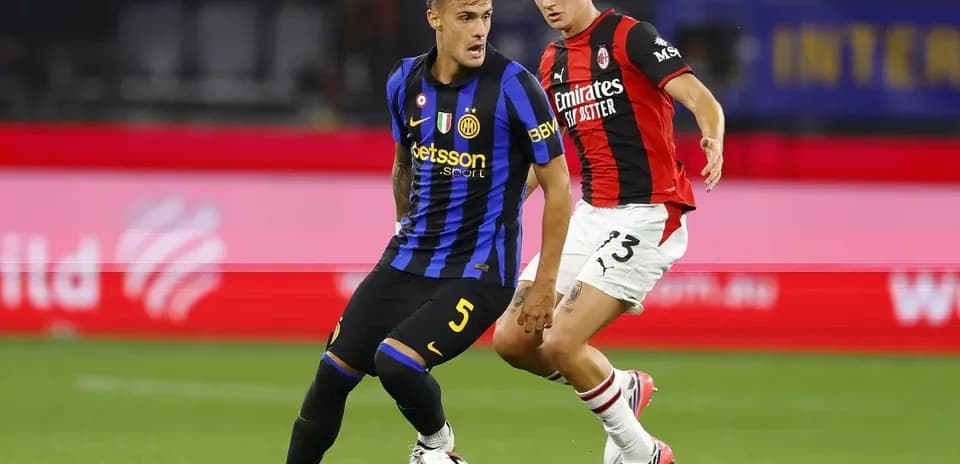 Inter Milan player dribbling past AC Milan defender