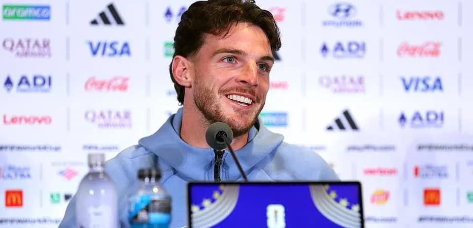 Player speaking at press conference with sponsor logos