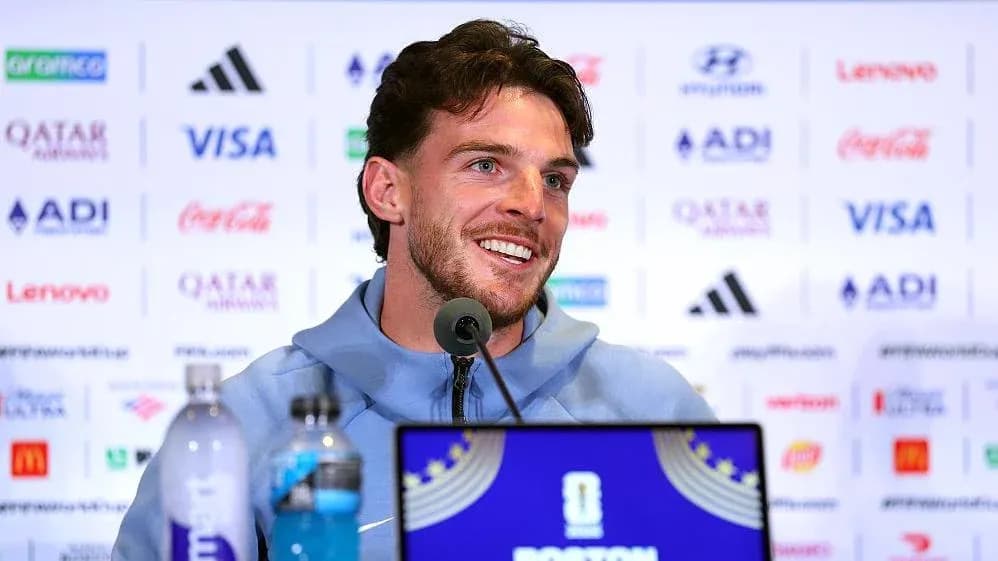 Player speaking at press conference with sponsor logos