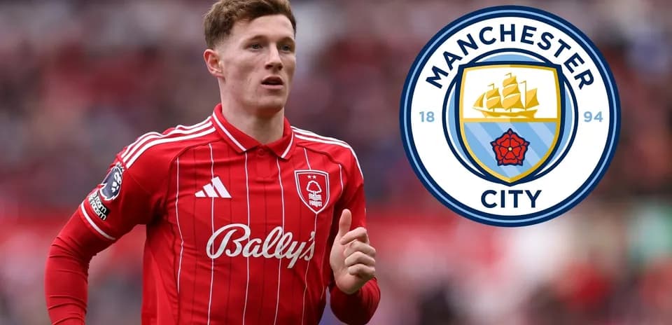 Player in red jersey running with Manchester City logo